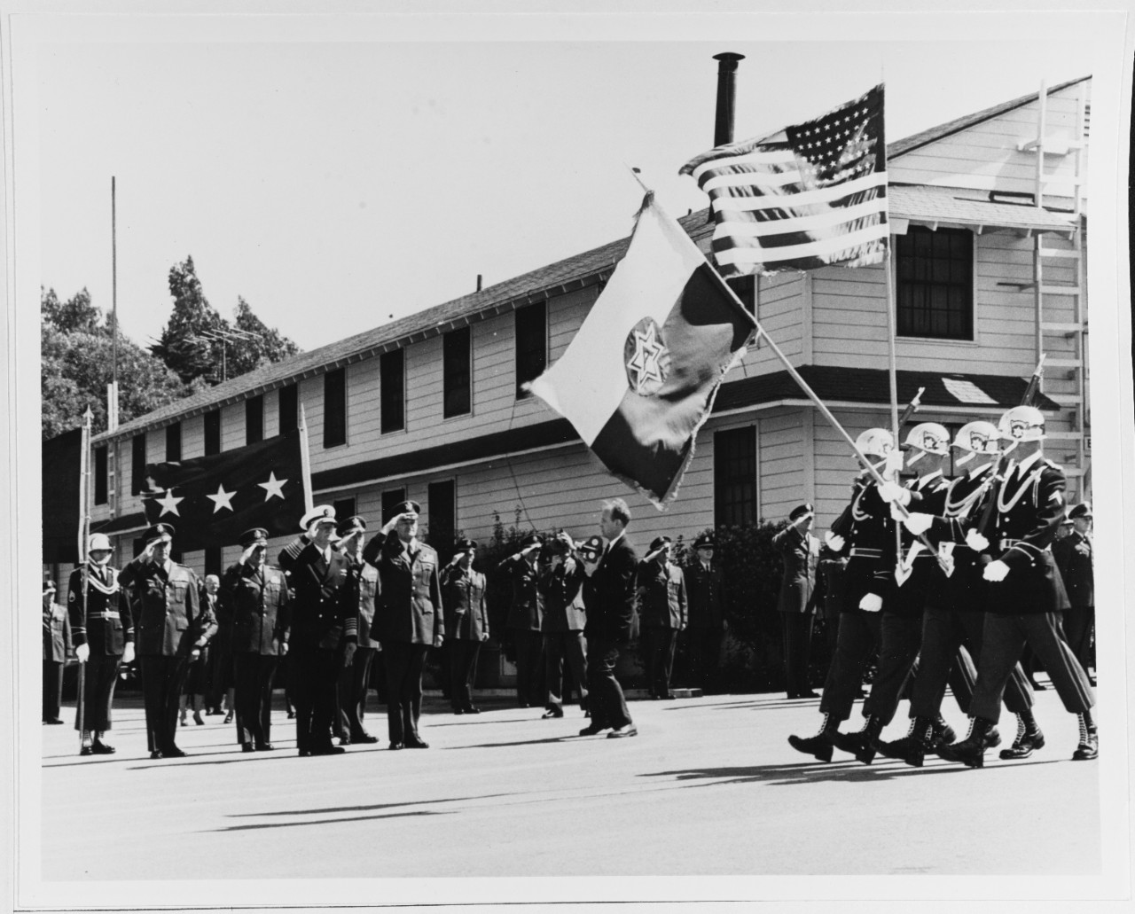 Fleet Admiral Nimitz and Lieutenant General Charles D. Palmer, Commanding General U.S. Sixth Army Salute the Passing Colors