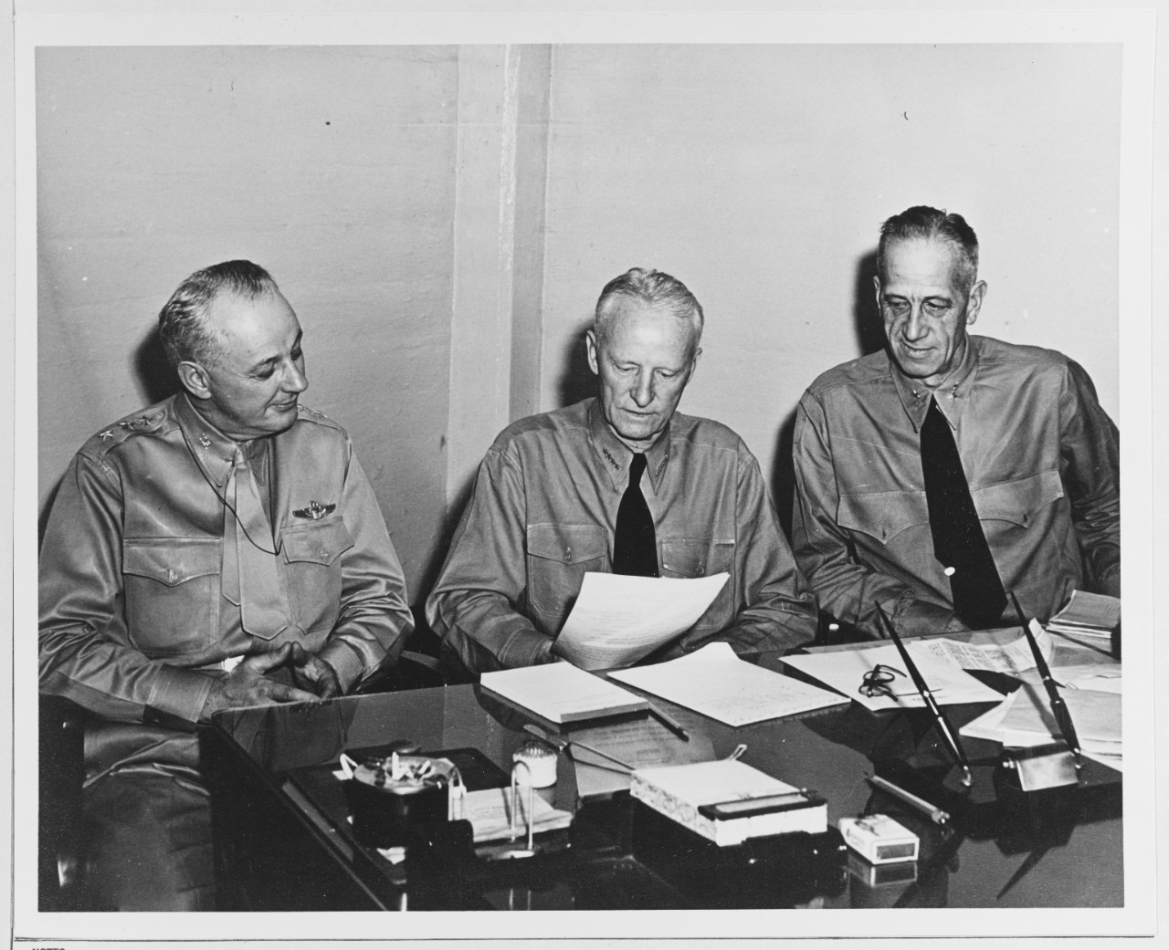 Admiral Chester W. Nimitz, USN, CINCPAC is shown with two of his staff officers