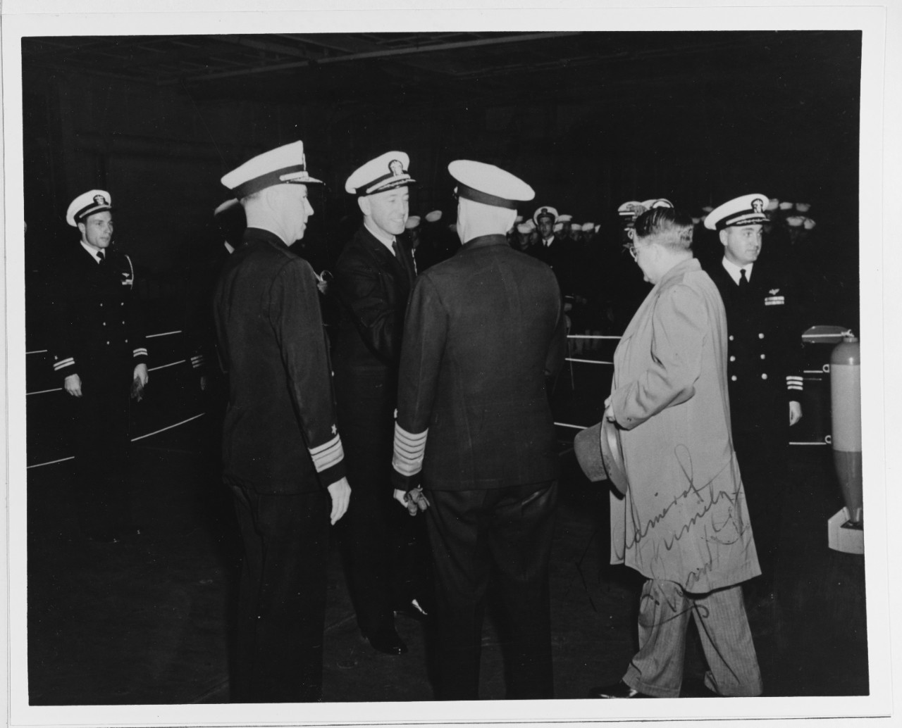 Fleet Admiral Chester W. Nimitz, CNO, (back to camera) is Introduced to some Officers