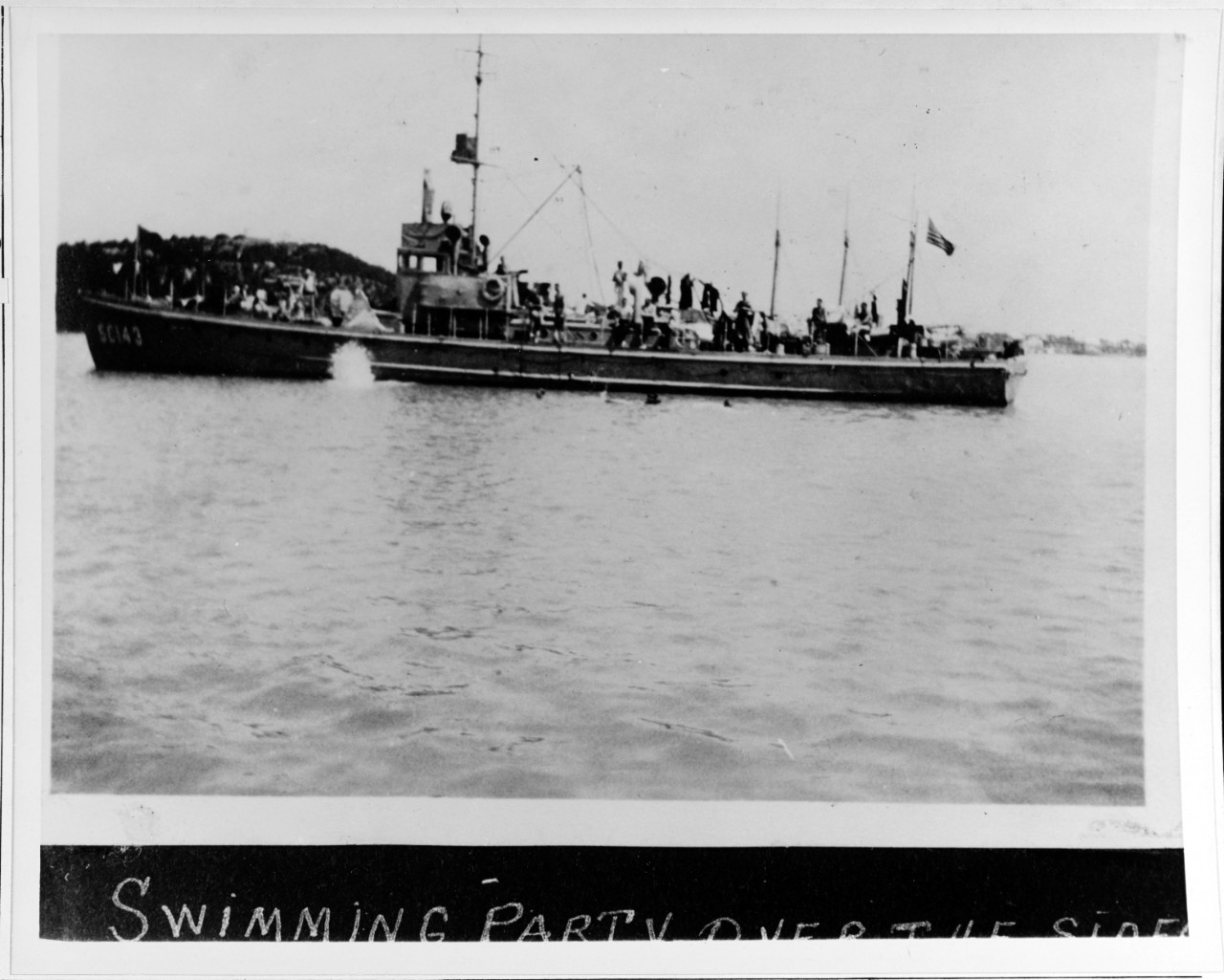 Crew of USS SC-143 swimming alongside the boat during World War I. 