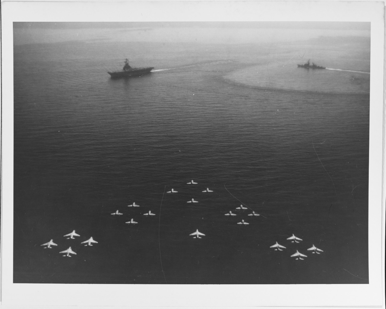 Formation of nine F8U crusaders and twelve A4D Skyhawks