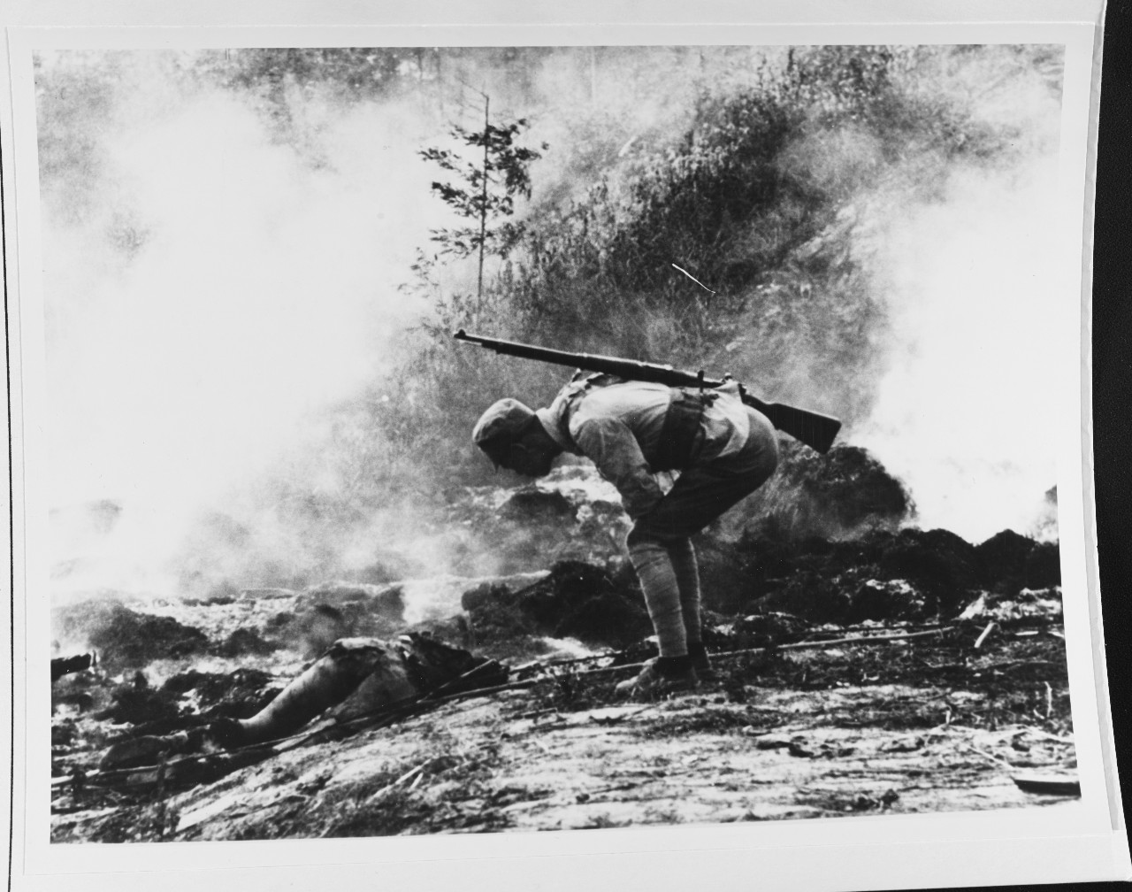 Chinese soldier inspecting a corpse during the fighting for Shanghai, China
