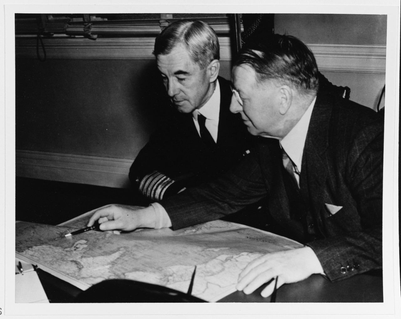 Secretary of the Navy Frank Knox (right) confers with Admiral Thomas C. Hart