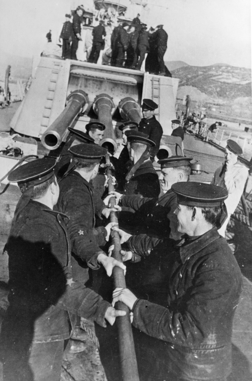 Sailors cleaning the barrel of a 7.1-in. main battery gun aboard a Soviet KIROV class cruiser during World War II