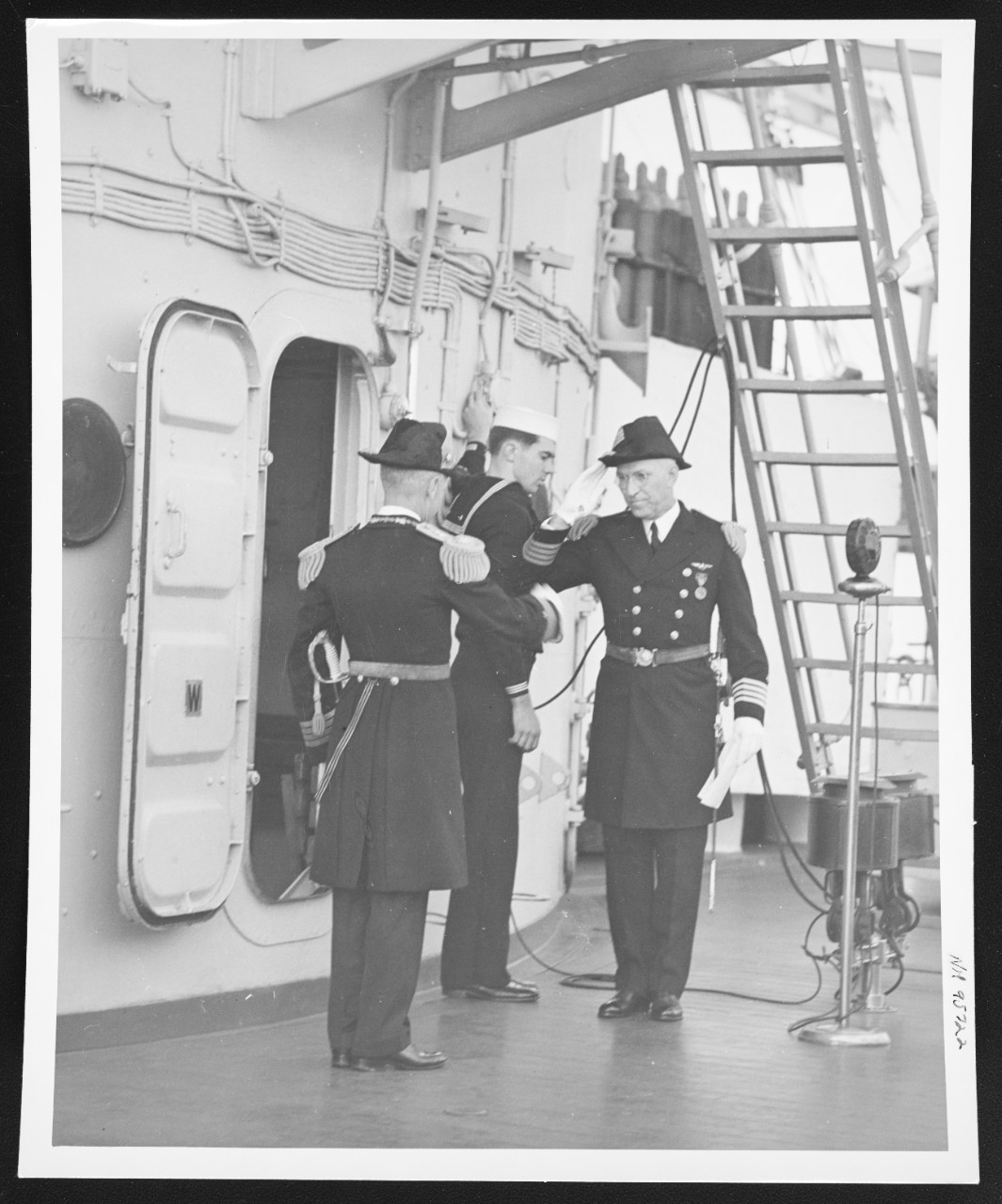 Captain Robert P. Molten (right) salutes Captain Albert C. Read
