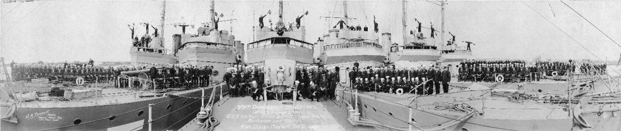 Officers &amp; Crews of Thirteenth Destroyer Division on board their ships in San Diego Harbor, California, 6 December 1919. Signalmen are sending semaphore messages from atop the ships' bridges. Panoramic photograph by O.A. Tunnell, Masonic Temple Building, San Diego. Ships present are (from left to right): Upshur (Destroyer # 144), Greer (Destroyer # 145), Elliot (Destroyer # 146), Aaron Ward (Destroyer # 132), Buchanan (Destroyer # 131) and Philip (Destroyer # 76).  Donation of Captain W.D. Puleston, USN (Retired), 1965.  U.S. Naval History and Heritage Command Photograph.