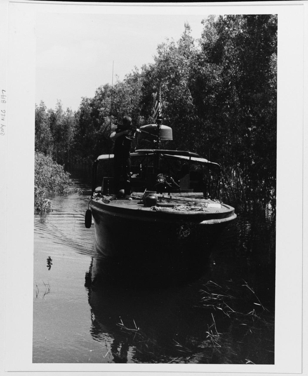 A PBR (river patrol boat) cruises on a canal in search of Viet Cong.