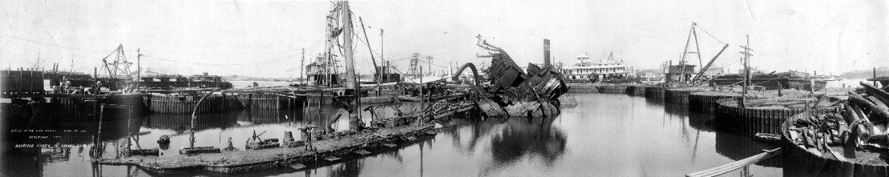 Wreck and salvage operation of the USS Maine (ACR-1), view from the starboard side, looking forward, June 16, 1911. Two different size copies available. Part of a series of eight oversize panoramic photos related to the salvage of the USS Maine. 