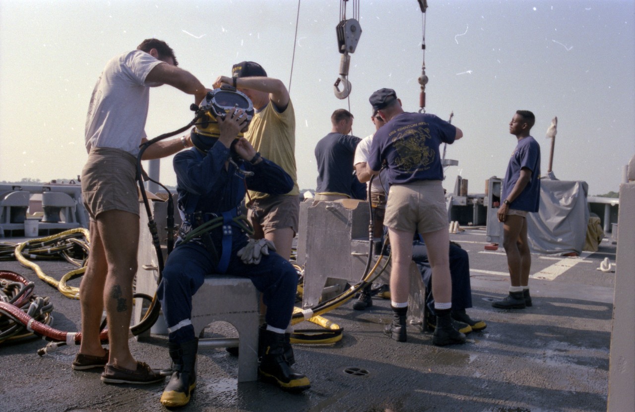 Divers on board USS Edenton (ATS-1) don diving gear