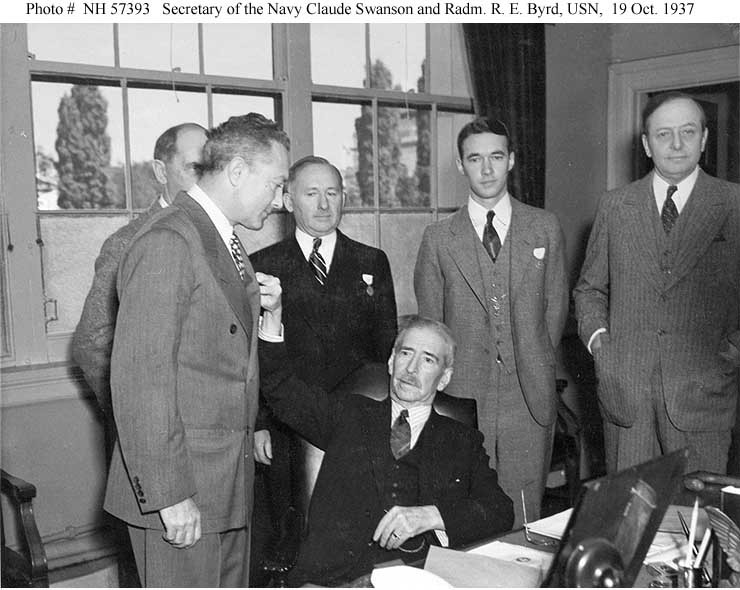 Photo #: NH 57393  Honorable Claude Swanson,  Secretary of the Navy, (sitting) and Rear Admiral Richard E. Byrd, USN,  (standing to the left)