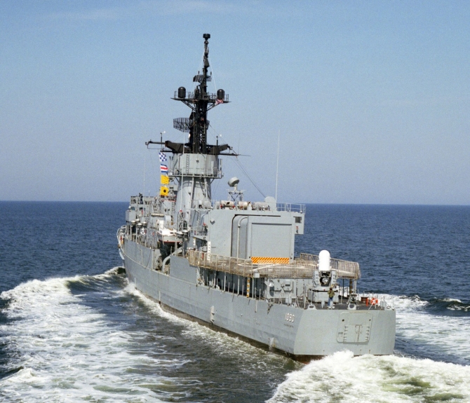 A port quarter view of Ainsworth with her wake churning the water as she passes, taken the same day on 1 May 1984. Note the Mk 15 Phalanx CIWS mount newly installed on her fantail, and the signal flags hoisted aloft. (PH1 Erickson, U.S. Navy Photograph 330-CFD-DN-SC-88-09140, Record Group 330 Records of the Office of the Secretary of Defense, 1921–2008, National Archives and Records Administration)