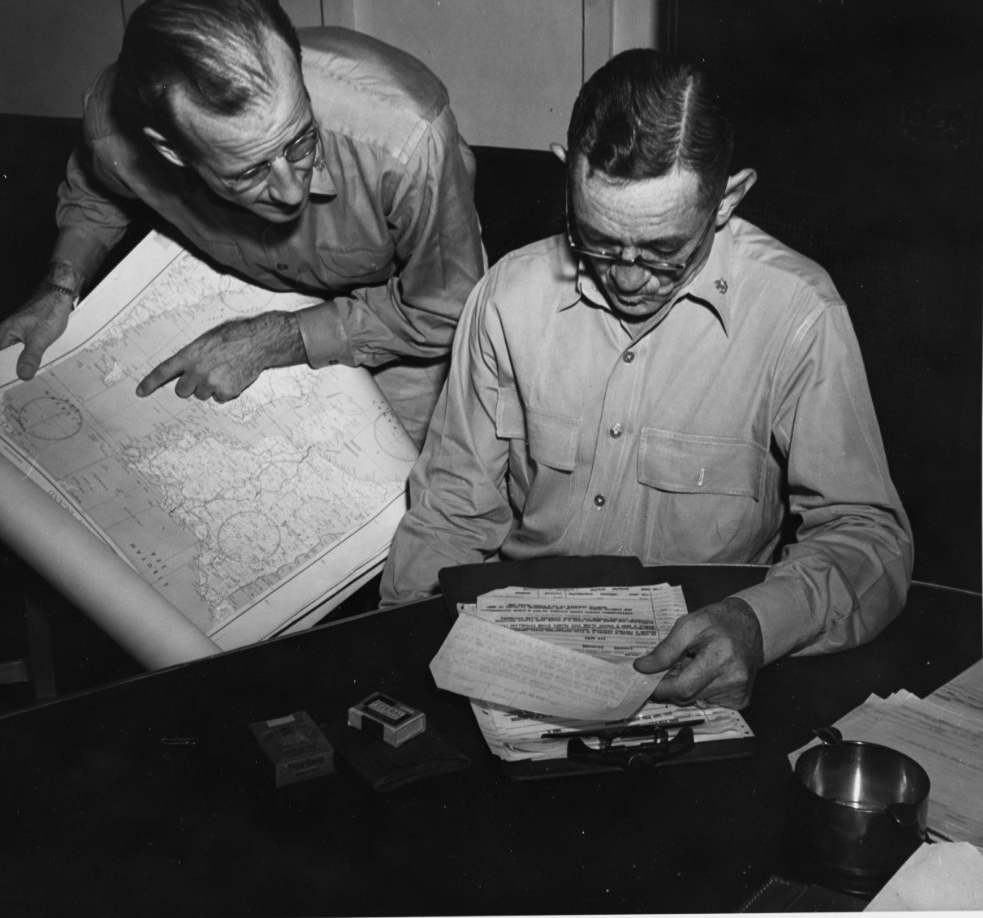 Lieutenant Commander J.E. Lawrence (left), ACI and Airplot Officer, and Commander M.C. Cheek, Staff Intelligence Officer